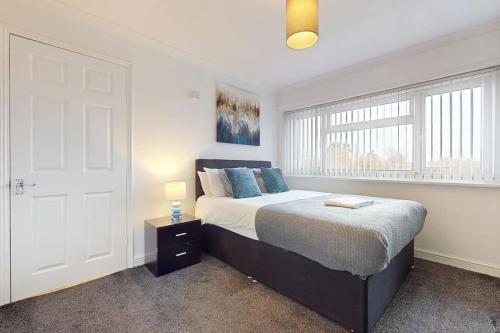 a bedroom with a bed and a white door at CONeN Dagenham Home in Goodmayes