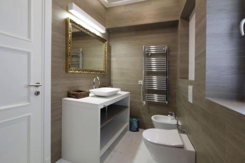 a bathroom with a sink and a toilet and a mirror at Stylish modern studio in Budva with a sea view in Budva