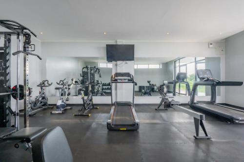 a gym with several treadmills and cardio machines at Mantis Akagera Game Lodge in Akagera