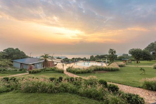 a view of the pool and the ocean at sunset at Mantis Akagera Game Lodge in Akagera