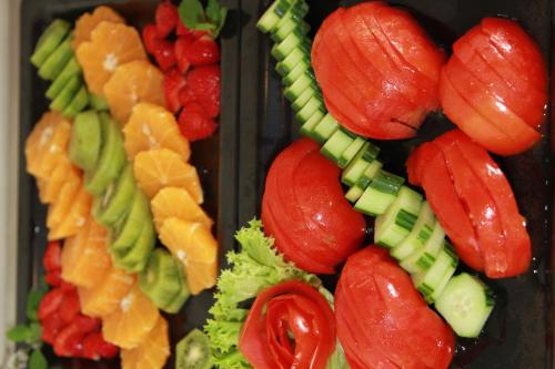 a tray of food with vegetables and fruit at Maria Beach Hotel in Kissamos