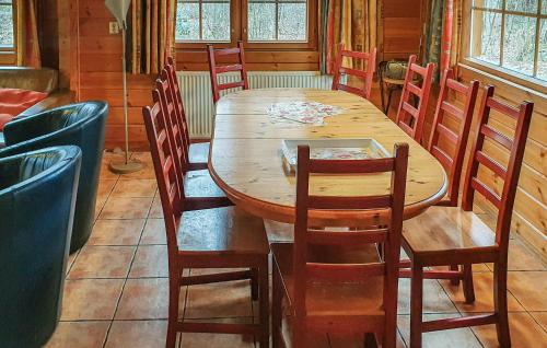 a wooden table and chairs in a room at Nice Home In Neede With Sauna in Gelselaar