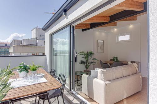 a balcony with a table and a couch at Santa Lucía in A Coruña