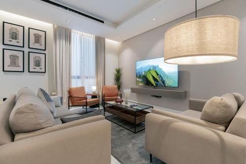 a living room with two couches and a tv at أكاريم الملقا Akareem AL-Malqa in Riyadh