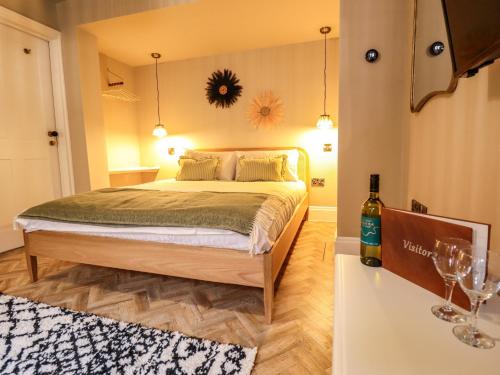 a bedroom with a bed and a bottle of wine at 17 Union Road Basement in Lincoln
