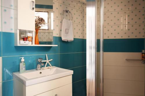 a bathroom with a sink and a shower at Cozy family home in Katouna in Katouna