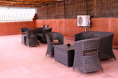 a row of chairs and a tv in a room at Riad ait Ben Haddou in Aït Ben Haddou