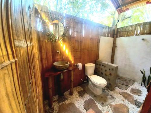a bathroom with a toilet and a sink at Avani del desierto in Villavieja