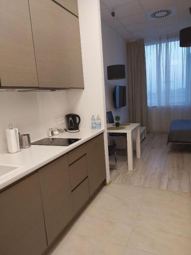 a kitchen with a sink and a table in a room at Zlatarooms in Warsaw
