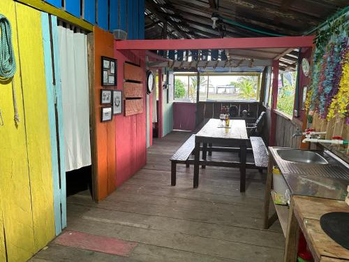 a dining room with a table and a colorful wall at Iguana Azul Pacific Paradise in Buenaventura