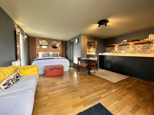 a bedroom with a bed and a desk with a table at Rockmount Rooms & Apartment in Tavistock