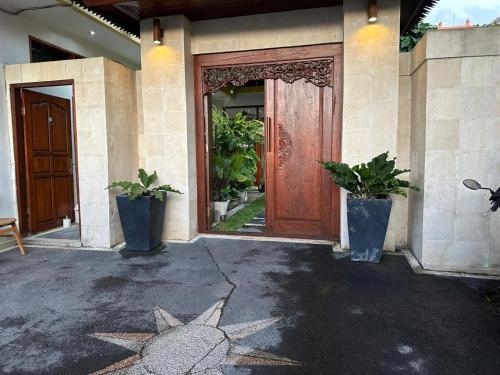 a front door of a house with a star on the ground at Zolina Villa 4 Bedrooms in Kerobokan
