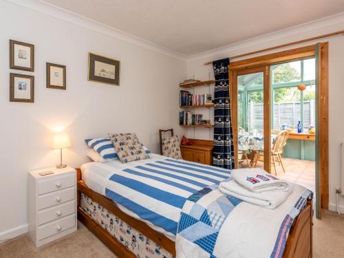 a bedroom with a bed with a blue and white comforter at 2 bed in Bognor Regis 79283 in Bognor Regis