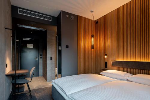 a bedroom with a bed and a desk and a chair at Zleep Hotel Prague in Prague