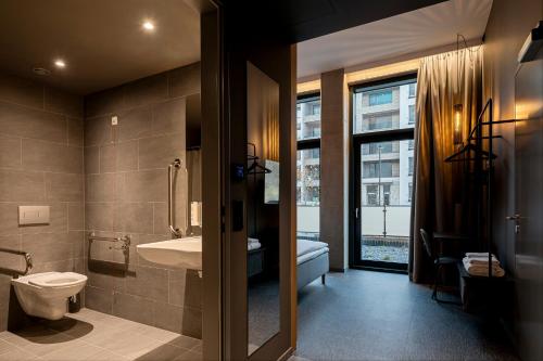 a bathroom with a toilet and a sink at Zleep Hotel Prague in Prague