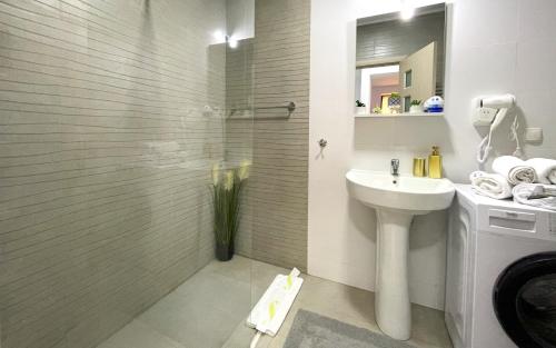 a bathroom with a sink and a toilet and a shower at Apartament Alma in Sinaia