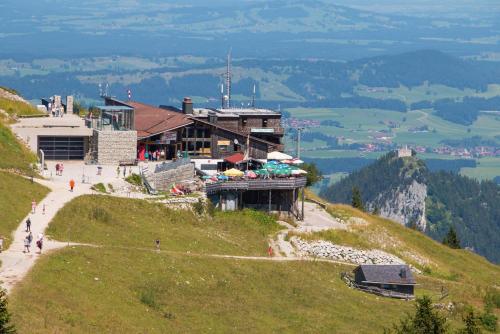 a building on the side of a hill with a building at Ferienwohnung Rommel in Pfronten