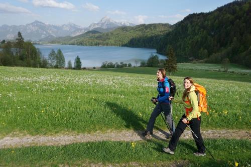 a man and a woman walking in a field at Ferienwohnung Rommel in Pfronten
