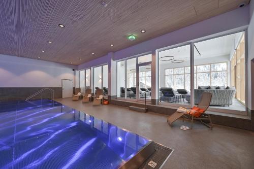 a swimming pool in a house with a swimming pool at Spacious Corner apartment in Aparthotel Kleinwalsertal in Mittelberg