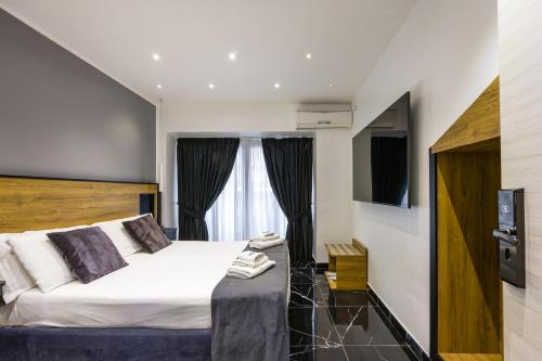 a bedroom with a large bed and a window at Hotel Bella Napoli in Naples