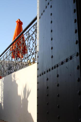a metal railing with a shadow of a fire hydrant at Riad Yamcha in Meknès