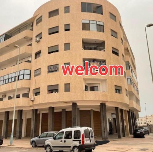 a large building with a welcome sign on it at appartement au centre d´Agadir in Agadir