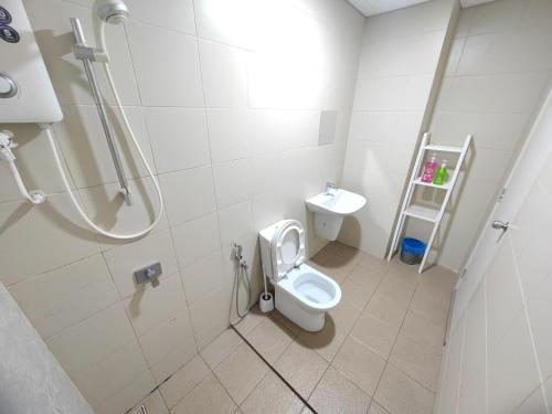 a bathroom with a toilet and a sink at Wan's Homestay i-City in Shah Alam