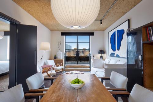 a living room with a wooden table and chairs at One Hundred Shoreditch in London