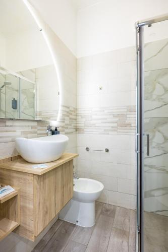 a bathroom with a sink and a toilet at Hotel Bella Napoli in Naples