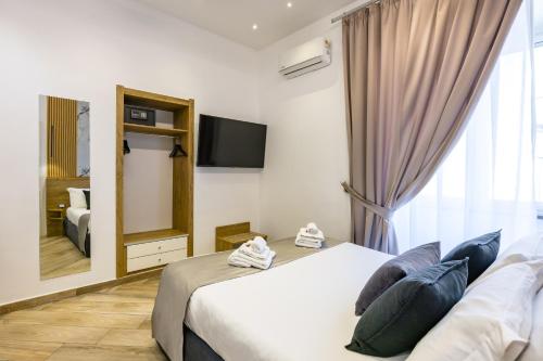 a hotel room with a bed and a mirror at Hotel Bella Napoli in Naples