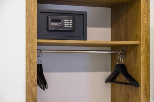 a wooden shelf with a radio on top of it at Hotel Bella Napoli in Naples