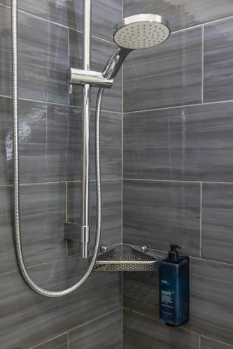 a shower with a shower head in a bathroom at Hotel Bella Napoli in Naples
