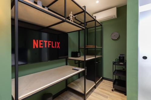 a room with bunk beds with a netflix sign on the wall at UrbanBllok5 in Tirana