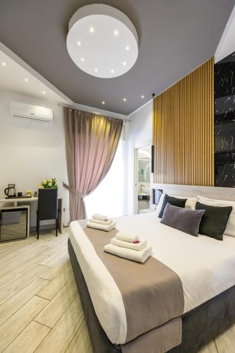 a bedroom with a large bed and a desk at Hotel Bella Napoli in Naples
