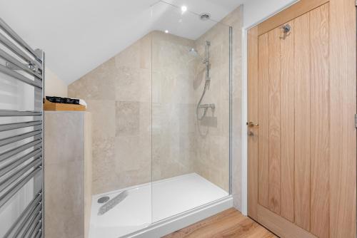 a shower with a glass door in a bathroom at Luxury Apartment in Stockton, sleeps 4, Free WIFI 