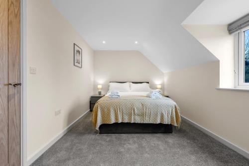 a white bedroom with a bed and a window at Luxury Apartment in Stockton, sleeps 4, Free WIFI 