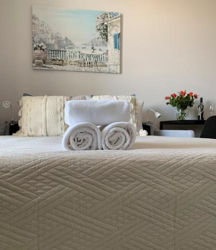 a bedroom with a bed with towels on it at Warsaw Home Suites in Warsaw