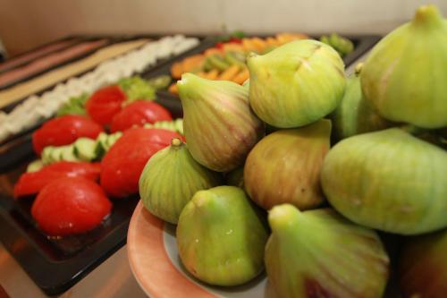 a plate of fruits and vegetables on a table at Maria Beach Hotel in Kissamos