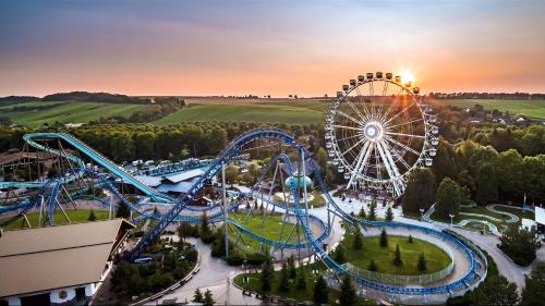 an amusement park with a ferris wheel at sunset at Logement calme + stationnement in Troyes