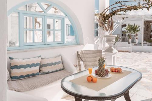 a living room with a coffee table and a couch at Dibellee Mykonos Studios in Glastros