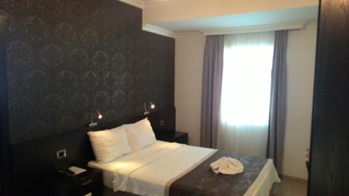 a hotel room with a bed and a window at Hotel Residence in Istanbul
