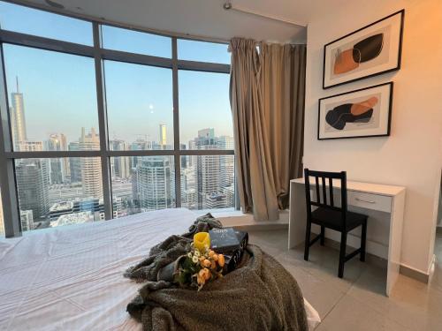 a bedroom with a bed and a desk with a window at ThePenthouse Coliving I in Dubai