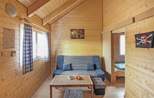 a living room with a couch and a table at Cozy Home In Rewal With Wi-Fi in Rewal