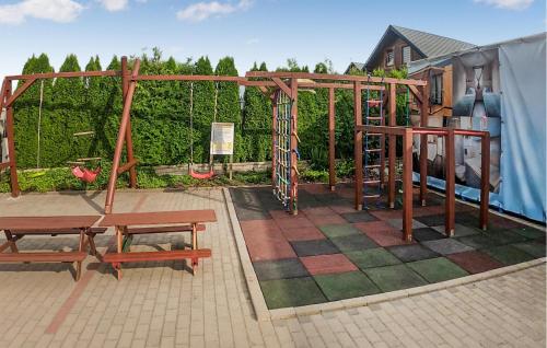 a playground with two benches and a swing at Cozy Home In Rewal With Wi-Fi in Rewal