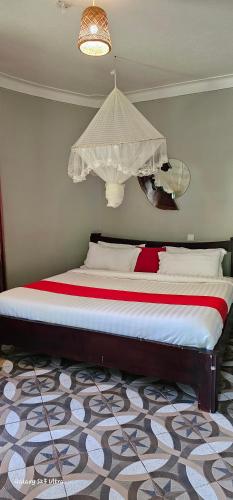 a bedroom with a large bed with a canopy at Tusubira village in Jinja