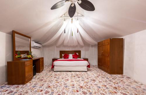 a bedroom with a bed and a ceiling fan at Regency Sealine Camp in Mesaieed
