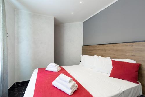 a bedroom with a bed with two towels on it at Hotel Bella Napoli in Naples