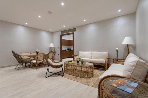 a living room with a couch and a table at Regency Sealine Camp in Mesaieed
