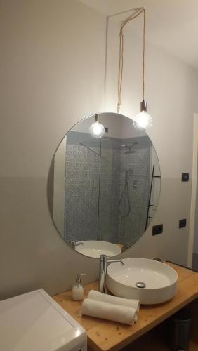 a bathroom with a sink and a mirror at Rocca d'Anfo B&B-Apartments Lake View in Rocca dʼAnfo