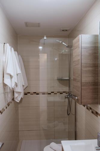 a bathroom with a shower with a glass door at La Cataleya in San Agustin